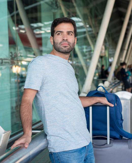 medium-shot-thoughtful-man-leaning-railing-airport